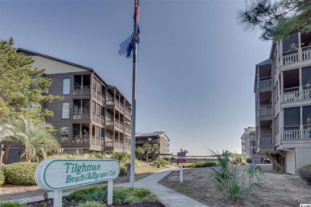tilghman beach and racquet club sign with condo building in back