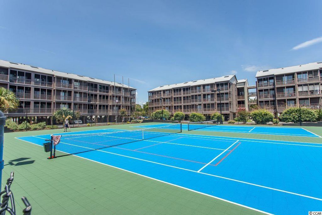 tennis court and condo units in the background